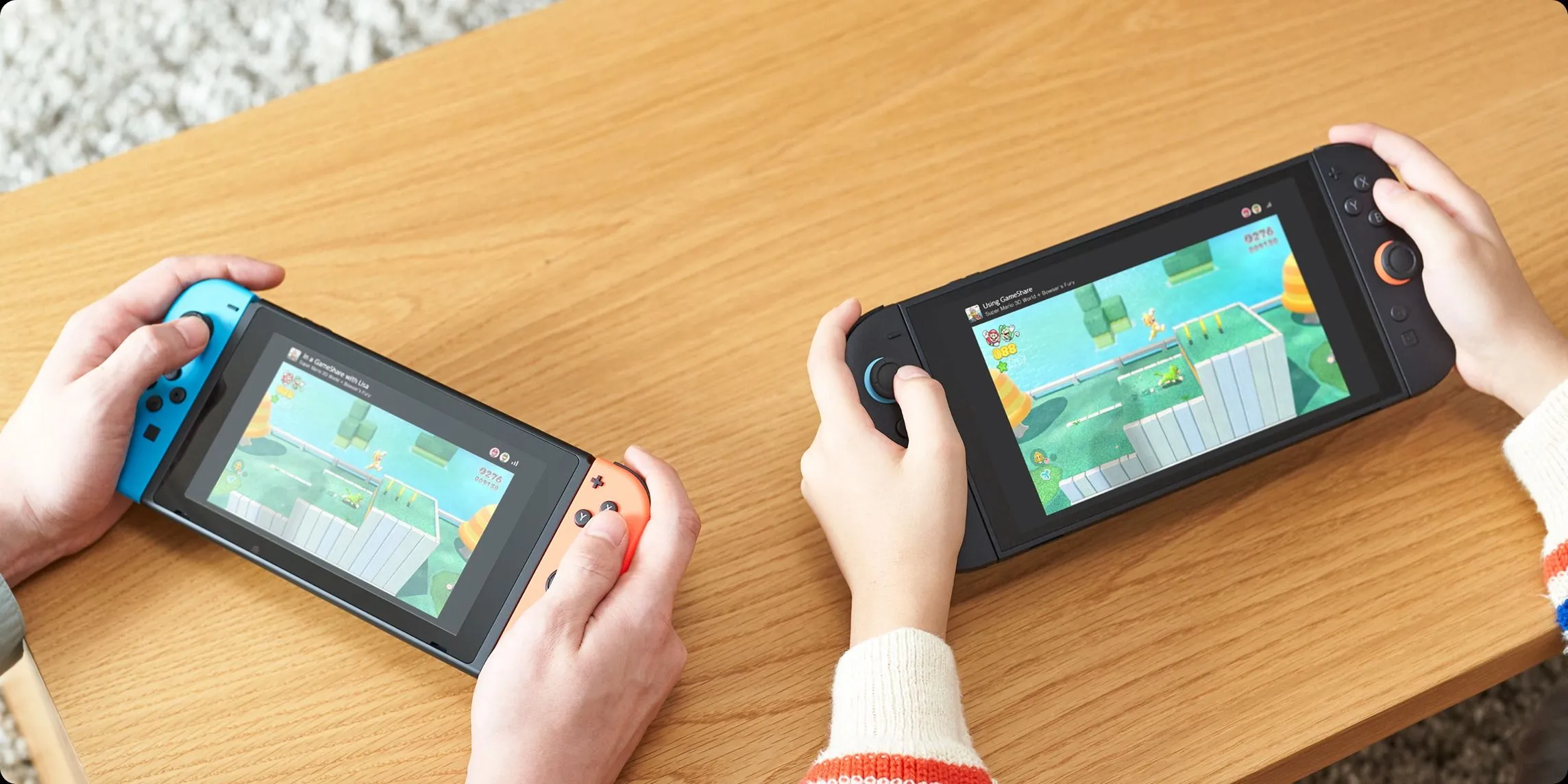 Hai máy Nintendo Switch 2 và Switch đời đầu đang sử dụng tính năng GameShare để chơi game nhiều người chơi.
