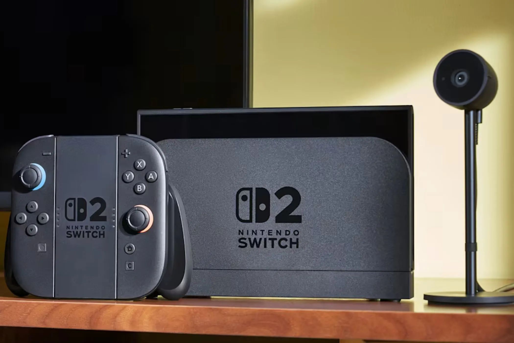 Hình ảnh minh họa máy chơi game Nintendo Switch 2 và camera trên bàn, biểu tượng cho tính năng tương thích ngược game với Switch đời đầu